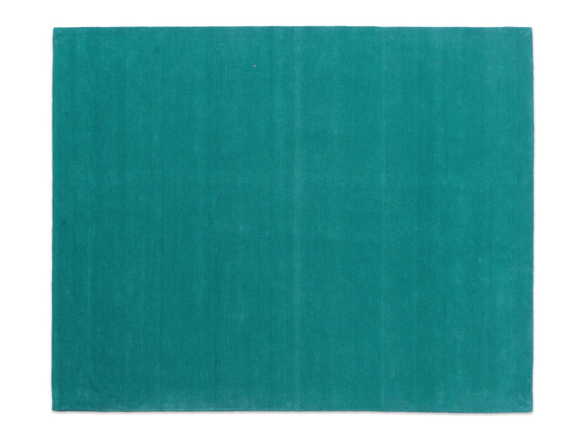 Handmade teal solid wool area rug, minimalist style, made in India